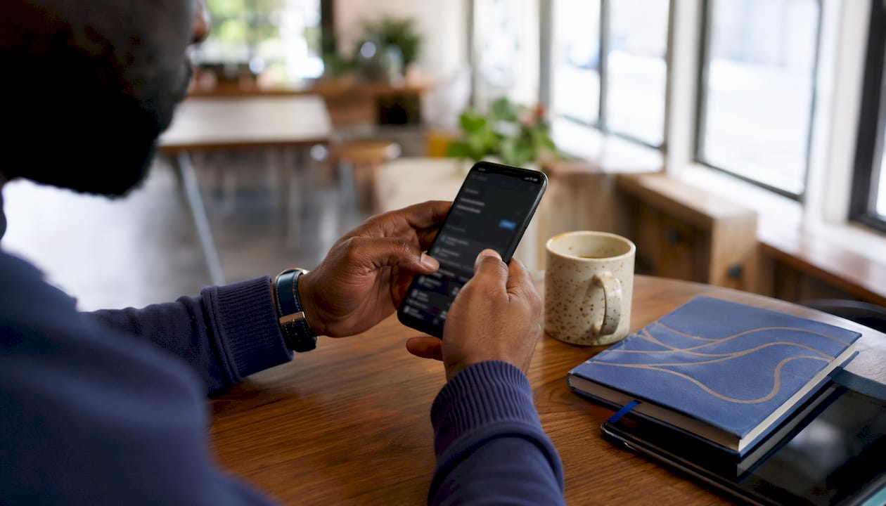 Hands verifying bank account on smartphone
