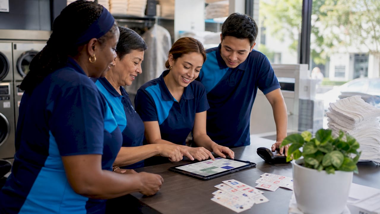 Staff moving digital order cards on tablet screen