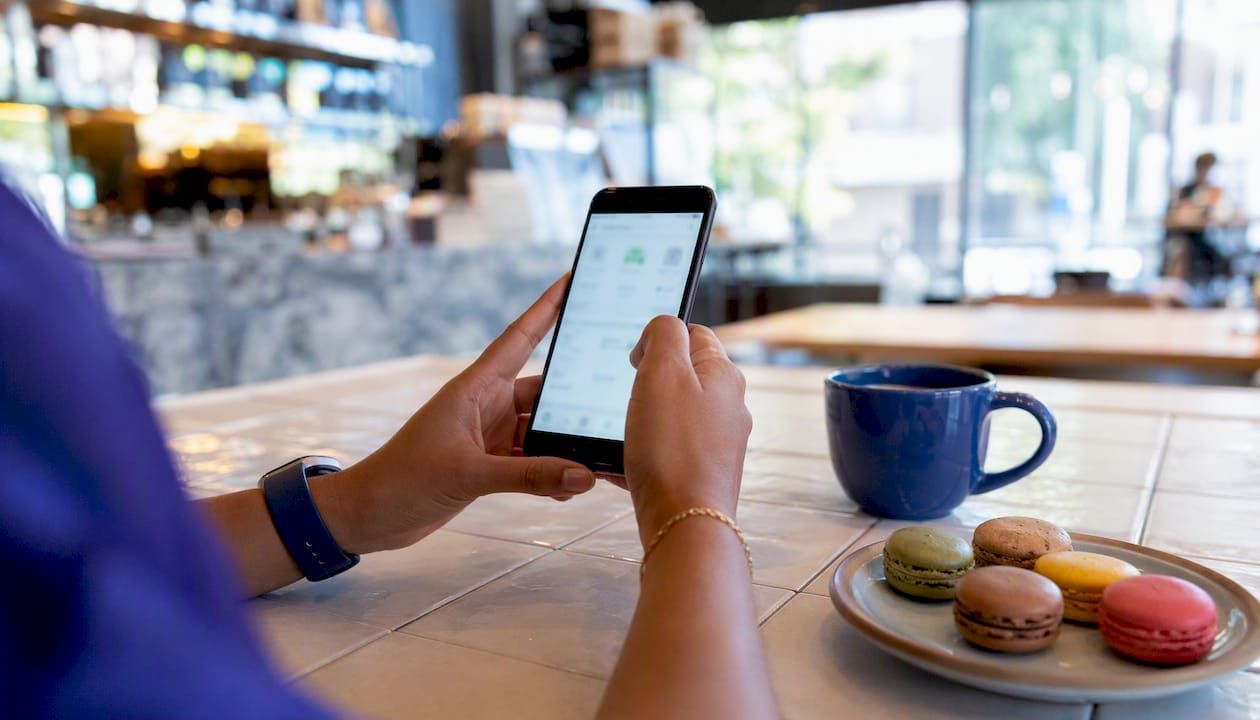 Hands holding smartphone with laundry app interface