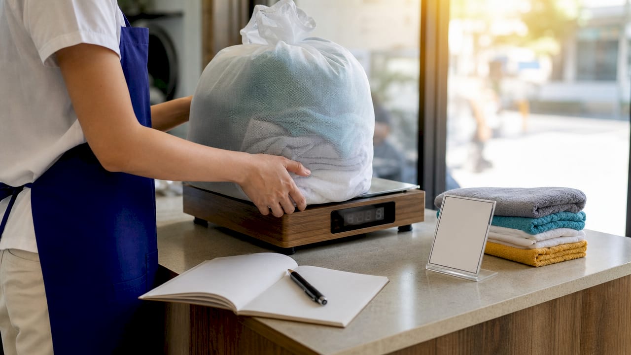 Laundry weighed on scale for pricing