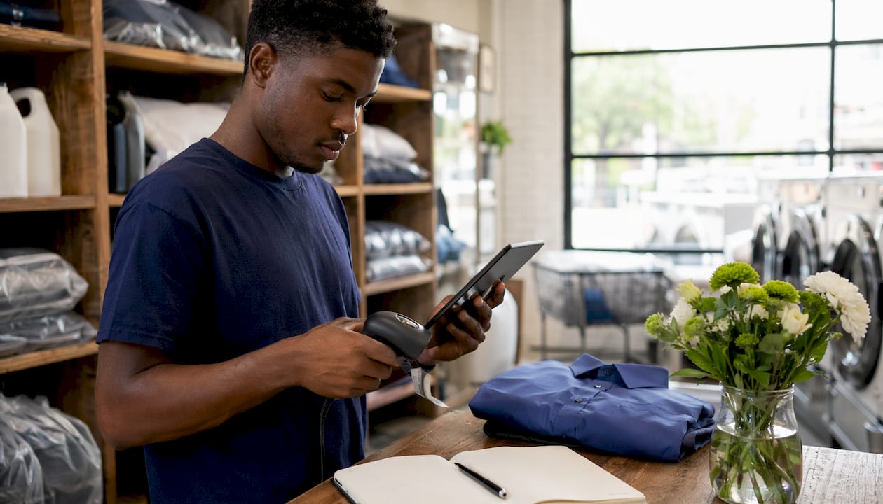 Attendant scanning garment tags with iPad