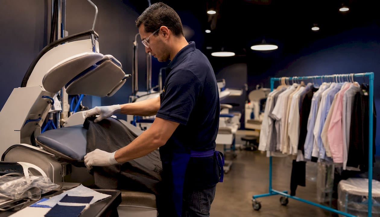Operator using pressing machine in dry cleaner