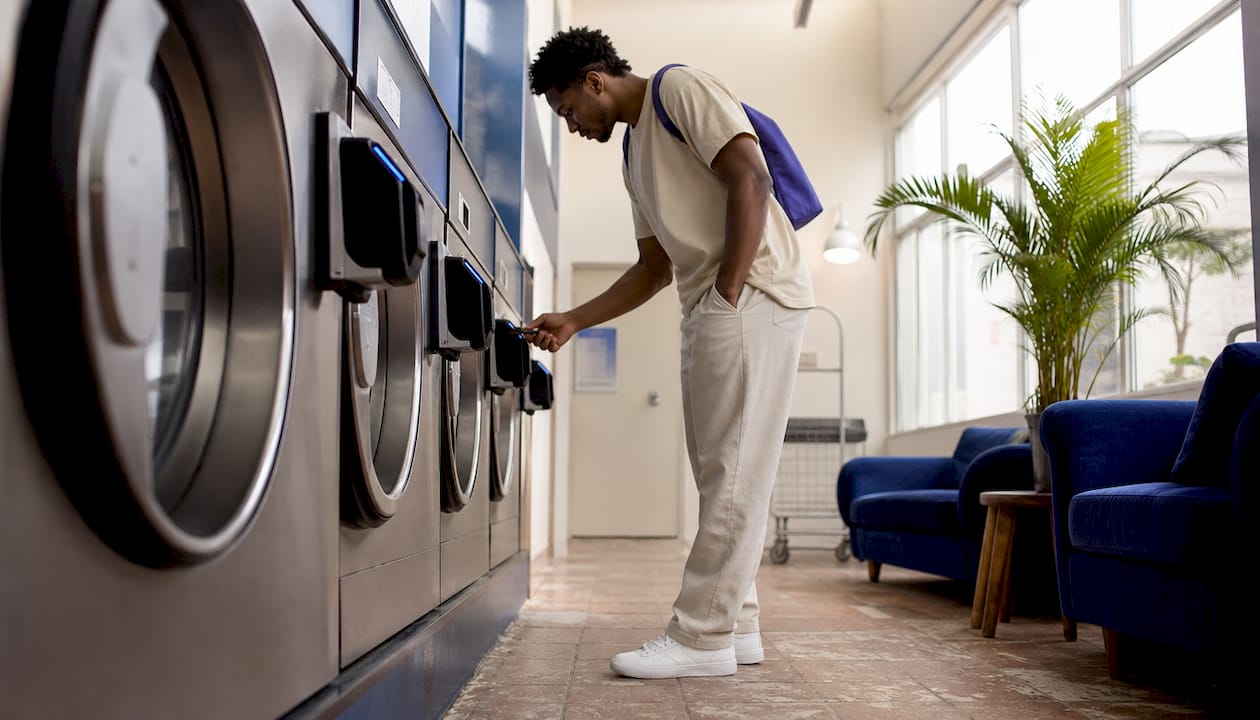Customer using card reader on washing machine